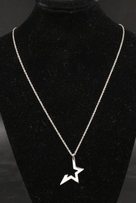 a necklace with a star pendant on a mannequin neck