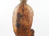 carved wooden figurine of a man with a bird on his head