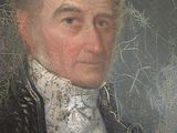 portrait of a man in a black coat and white shirt