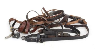 many different types of leather belts on a white background