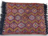 a close up of a colorful rug with fringes on it