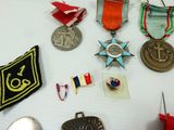 many medals and badges on the table