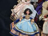 five dolls that are sitting on a black surface