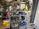 a garage with a lot of clutter and tools in it