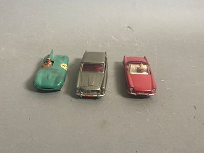 three toy cars sitting next to each other on a table