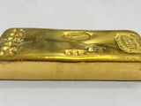a gold bar sitting on top of a white table