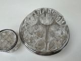a picture of a silver plate with a flower design on it