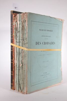 an old book sitting on top of a table covered in papers