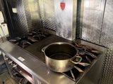a pot on the stove in the kitchen of a restaurant