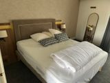 a bed with a white comforter and pillows on it