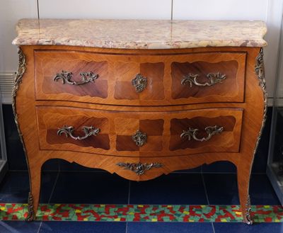 a marble top chest of drawers in a room