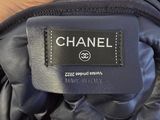 someone is holding a chanel bag with a label on it