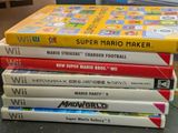 several nintendo wii games stacked on top of each other on a table