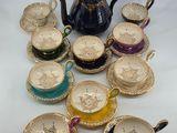many cups and saucers that are sitting on a table