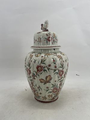 a large vase with a lid sitting on a table