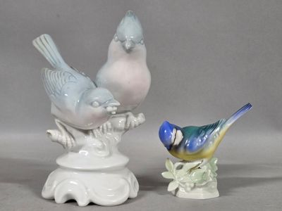two figurines of birds sitting on top of each other