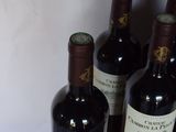 several bottles of wine sitting on top of a table next to each other