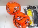 two soccer balls sitting on a table next to each other