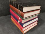 a stack of books sitting on top of each other on a table