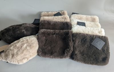 several pairs of slippers are lined up on a white surface