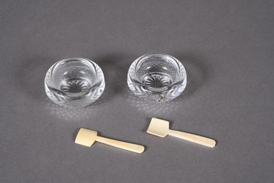 two glasses of water and a toothbrush on a table
