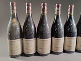 six bottles of wine are lined up in a row on a table