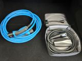 two cables and a charger in the trunk of a car