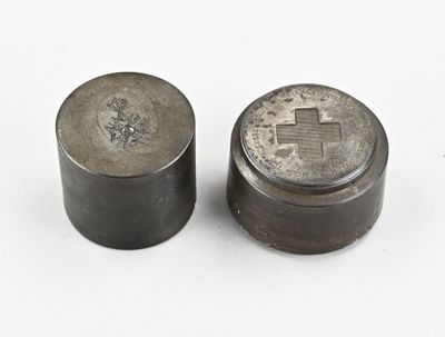 pair of old silver coins sitting on top of a white surface