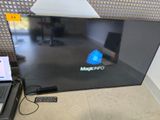 a laptop sitting on the floor next to a monitor