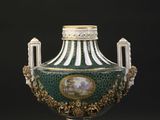 a green and white vase with a picture on it
