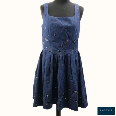 a dress on a mannequin stand with a white background