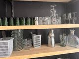 a shelf full of glassware and other items on it