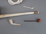 a baseball bat, a ball, and some other items on a table