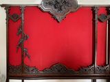 a red wall with a wooden headboard and a red wall