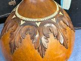 a brown vase sitting on a blue table next to suitcases