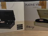two boxes with a record player sitting on top of a wooden table