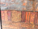 a close up of an old wooden box with a pattern on it