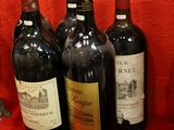 several bottles of wine are lined up on a red table