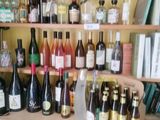 many bottles of wine sitting on a shelf in a room