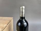 a bottle of wine sitting next to a wooden box