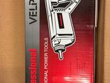 the box is open to show the contents of a portable power tool
