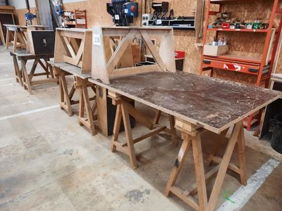 many pieces of wood sitting on a table in a workshop