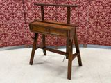 a small wooden desk with a chair on top of it