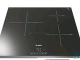 a close up of a black stove top with a glass top