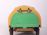 a green and yellow toy truck on a white surface