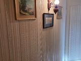 a picture of a hallway with pictures on the wall