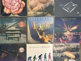 many different album covers on the table together