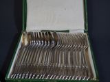 silverware in a green box on a black surface