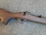 a close up of a rifle laying on the ground