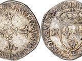 a silver coin with a shield on the front and a shield on the back